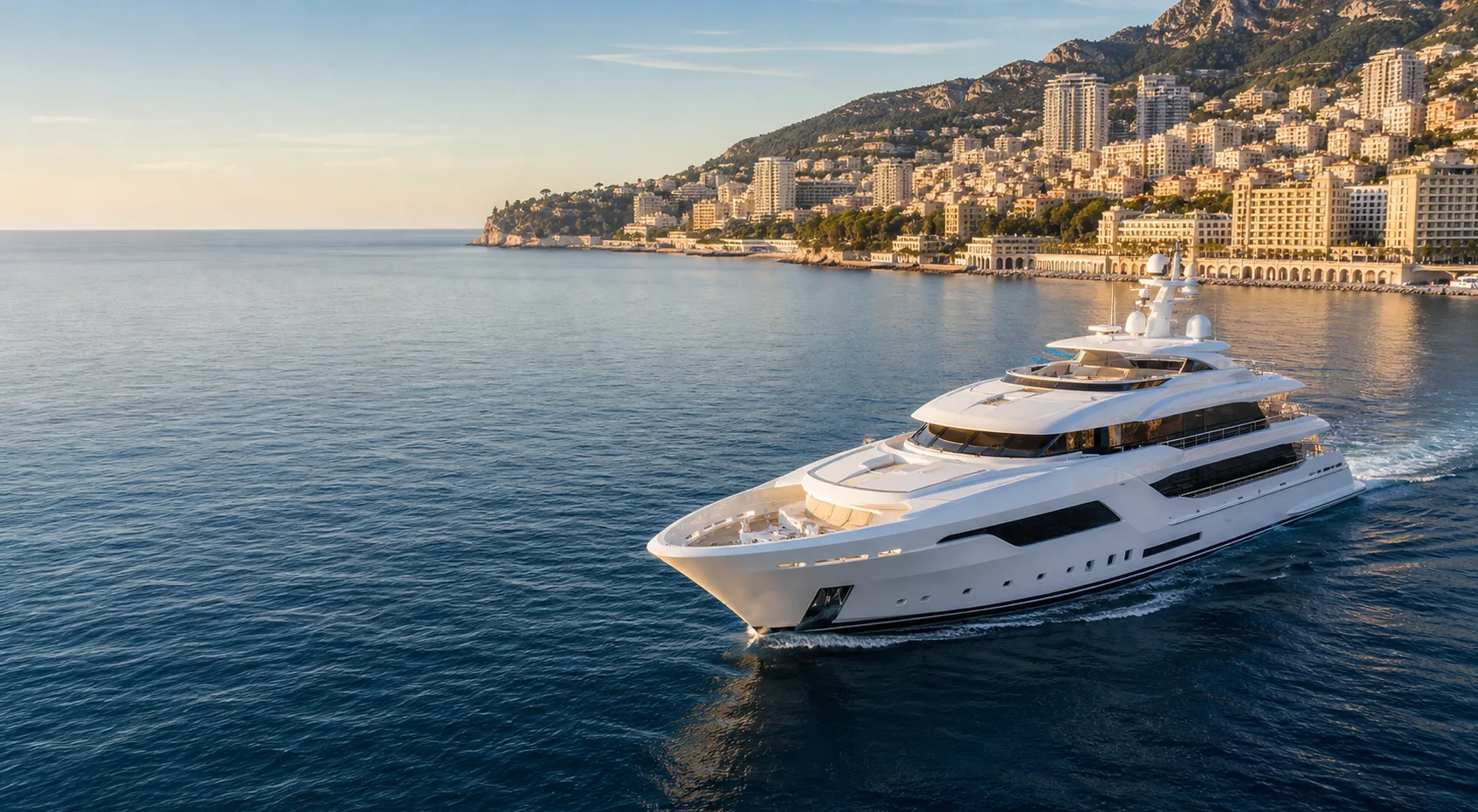 Luxury superyacht cruising along the Monaco coastline