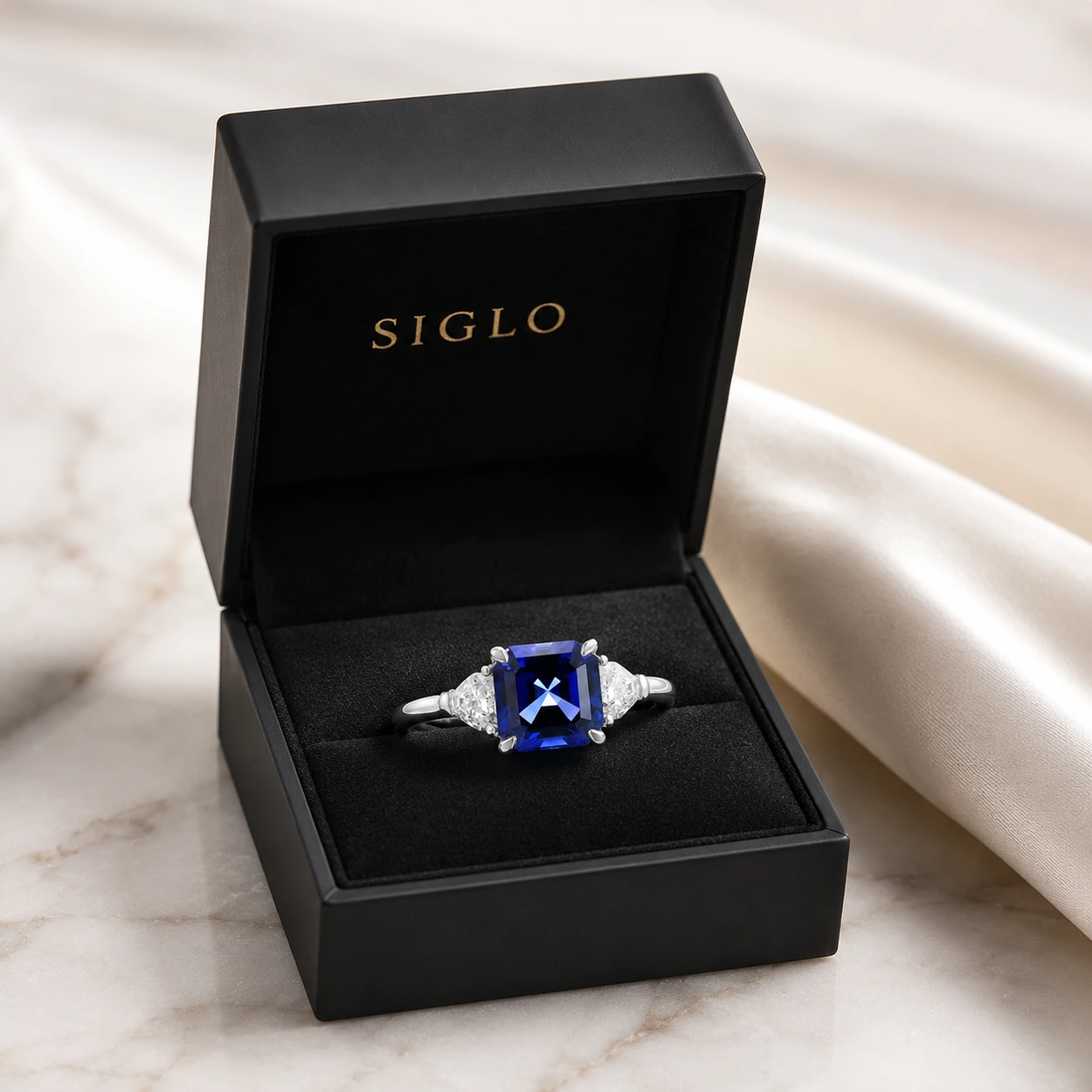Three stone sapphire ring presented in a luxury black SIGLO jewelry gift box