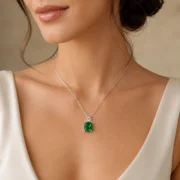 Cushion cut lab-grown emerald necklace shown at 45 degree view