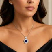 Woman wearing SIGLO lab-grown blue sapphire halo necklace