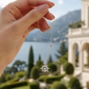 Hand holding SIGLO fine jewelry against a Mediterranean backdrop