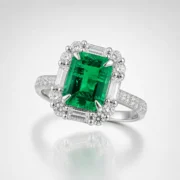 Emerald halo ring with vivid green center stone displayed in a luxury jewelry setting