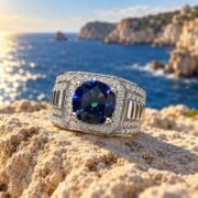 Side profile of a blue moissanite ring with a wide geometric band