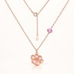 Rose gold paw pendant necklace with pink gemstone front view