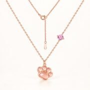 Rose gold paw pendant necklace with pink gemstone front view