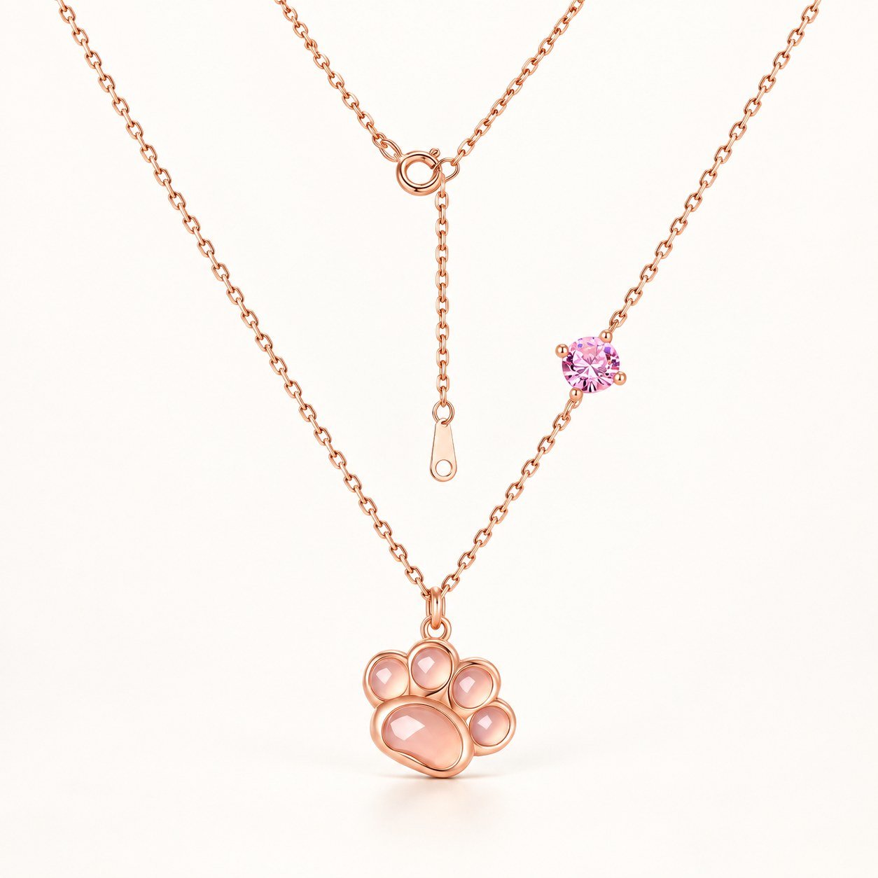 Rose gold paw pendant necklace with pink gemstone front view