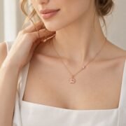 European woman wearing a rose gold paw pendant necklace