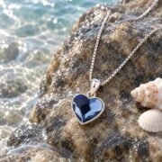 Blue Heart Necklace displayed in an elegant ocean-inspired scene