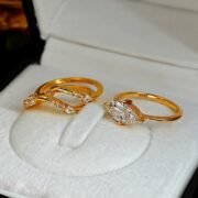 Elegant model wearing a marquise diamond ring with layered bands