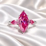 Angled view of the Rosé Promise three-stone pink diamond ring