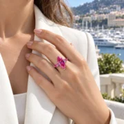 Close-up of a hand wearing the pink marquise diamond ring with two side stones