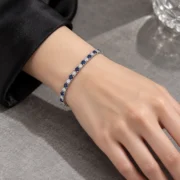Blue sapphire and lab-grown diamond tennis bracelet in a styled jewelry display