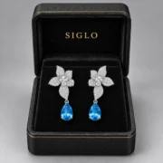 Azure Blossom blue topaz teardrop earrings presented in a SIGLO jewelry gift box