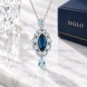 Side view of the Midnight Cascade pendant showing the raised center setting and suspended drop