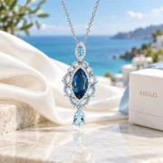 Angled view of the Midnight Cascade pendant showing its layered blue stones and silver setting