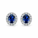 Sapphire halo stud earrings with oval deep blue centers and sparkling accents in S925 sterling silver