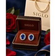 Royal Bloom sapphire halo stud earrings presented as a pair in a SIGLO jewelry gift box