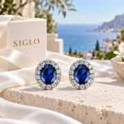 Royal Bloom oval blue sapphire earrings arranged in an elegant jewelry display