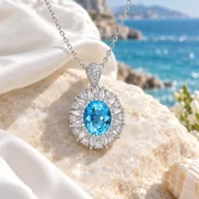 Natural blue topaz halo necklace with a sterling silver chain in an elegant jewelry display