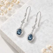 45-degree view of Twilight Dew earrings showing the blue topaz settings and cubic zirconia details