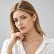 Twilight Dew silver drop earrings with blue teardrop gemstones arranged in an elegant jewelry display
