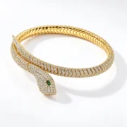 Angled view of the gold-tone serpent head and scale-like details on the S925 silver bangle