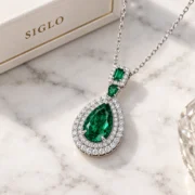 45-degree view of the Enchanted Forest necklace showing its pear-shaped green center and layered halo