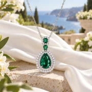 Enchanted Forest green gemstone pendant and fine silver chain arranged in an elegant jewelry display