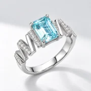 SIGLO light blue emerald-cut ring with sparkling accent stones, 45-degree v