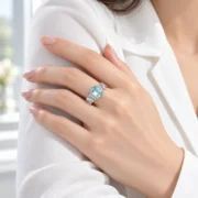 Model wearing a SIGLO light blue emerald-cut ring with a white blouse