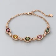Angled view of oval tourmaline settings and cubic zirconia halos in rose-tone S925 silver