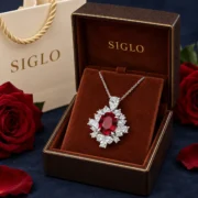 Crimson Flame ruby halo necklace presented in a SIGLO jewelry gift box