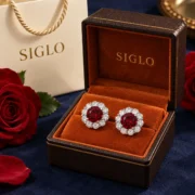 Crimson Blossom ruby halo stud earrings presented as a pair in a SIGLO jewelry gift box