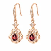 Front view of SIGLO Golden Ember gold plated garnet earrings