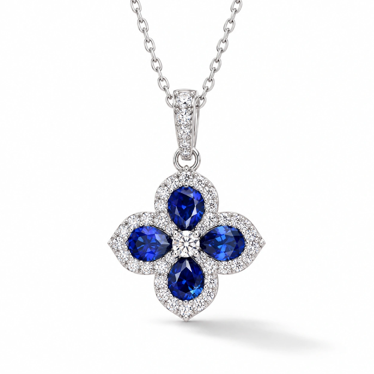 siglo-royal-blue-clover-necklace-front Sapphire clover necklace with four deep blue pear-shaped stones and sparkling halos in S925 silver