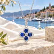 Blue Fortune sapphire clover necklace arranged with its fine sterling silver chain in an elegant jewelry display