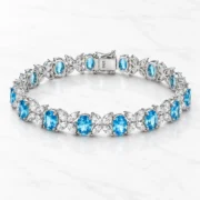 Angled view of the oval blue settings and sparkling butterfly links on the Ocean Wings bracelet