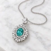 Angled view of the layered floral halo and three-leaf connector on the Ocean Majesty necklace