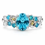 Front view of the Blooming Reverie blue flower ring with an oval blue-green center