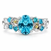 Front view of the Blooming Reverie blue flower ring with an oval blue-green center