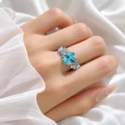 Blooming Reverie blue flower ring worn on the hand, showing its botanical details
