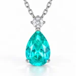 Front view of the Mermaid Tear teal teardrop necklace with a round sparkling accent