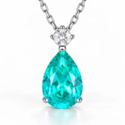 Front view of the Mermaid Tear teal teardrop necklace with a round sparkling accent
