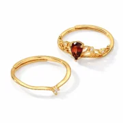 Angled view of the crown scrollwork and adjustable open bands on the S925 silver garnet ring set