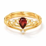 Crimson Reign garnet ring set with a pear-shaped natural garnet crown ring and matching accent band