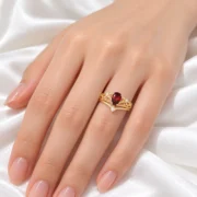 Model wearing the Crimson Reign garnet crown ring stacked with its matching accent band