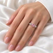 True Love pink rose ring worn on the hand, showing its floral silver details